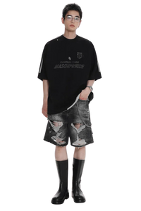 Model wearing black Masonprince Champion League Tee paired with ripped denim shorts and black boots