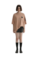 Masonprince Champion League Tee in soft peach color, styled with black shorts and knee-high socks