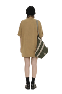 Back view of person wearing Masonprince colorful star tee oversized brown dress with black beanie and striped shoulder bag