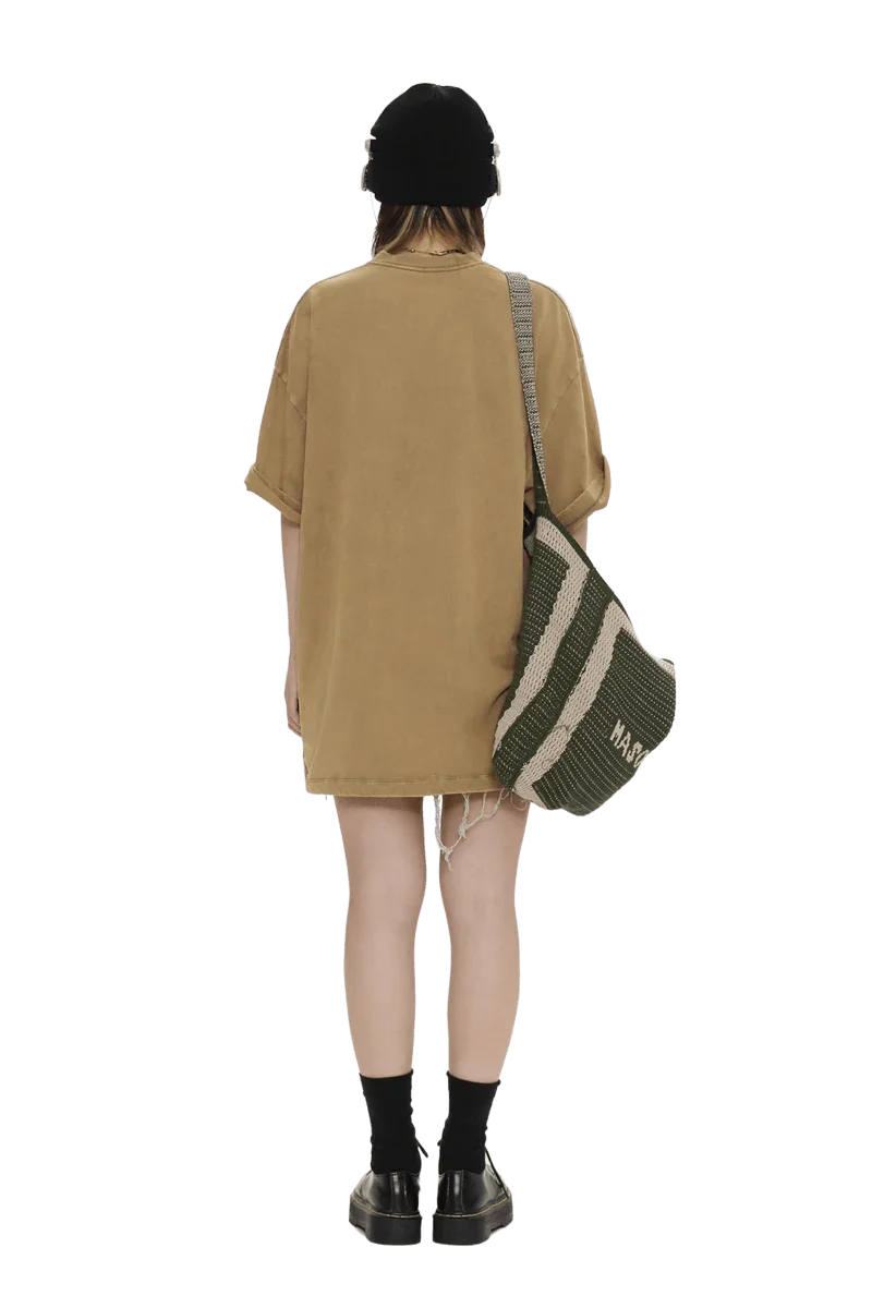 Back view of person wearing Masonprince colorful star tee oversized brown dress with black beanie and striped shoulder bag