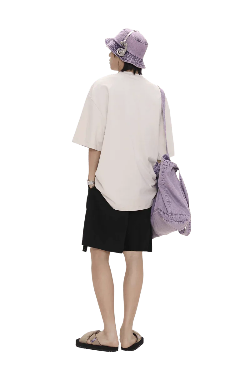 Back view of person wearing Masonprince colorful star tee oversized with black shorts and purple bucket hat and bag