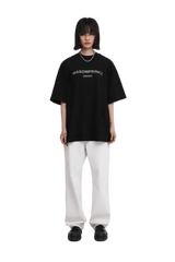 Masonprince Faded Logo Tee in black with casual oversized fit, paired with white pants