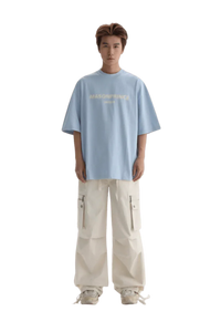 Light blue Masonprince Faded Logo Tee paired with white cargo pants for a trendy casual look