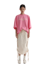Masonprince Faded Logo Tee in pink worn with a stylish skirt for a trendy casual look