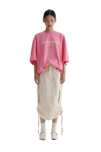Masonprince Faded Logo Tee in pink worn with a stylish skirt for a trendy casual look
