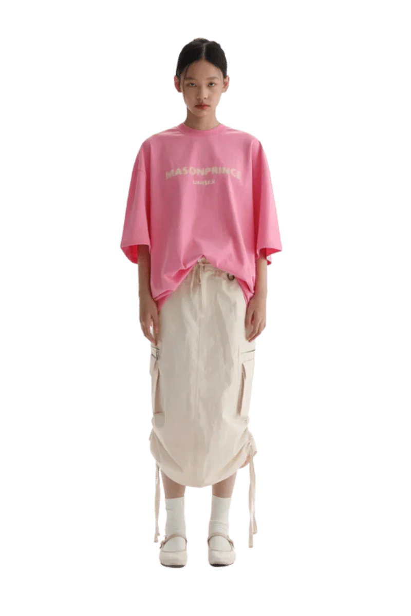 Masonprince Faded Logo Tee in pink worn with a stylish skirt for a trendy casual look