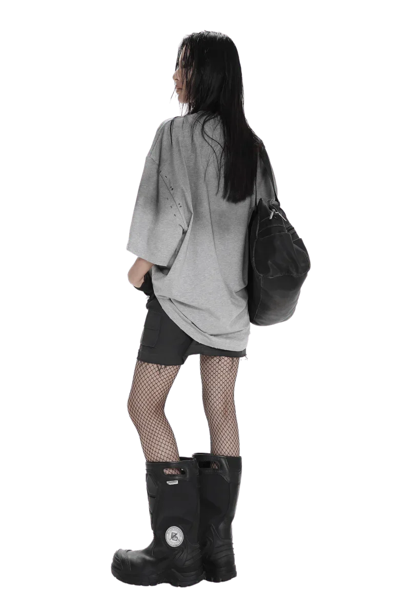 Woman wearing Masonprince Gradient Tee gray oversized shirt with black shorts and boots
