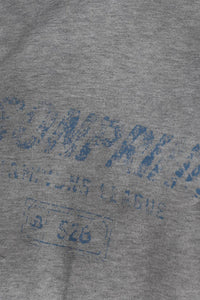 Close-up of gray fabric with faded blue print on Masonprince Gradient Tee clothing