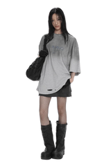 Model wearing Masonprince Gradient Tee oversized gray gradient shirt with distressed details and black accessories