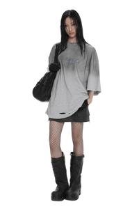 Model wearing Masonprince Gradient Tee oversized gray gradient shirt with distressed details and black accessories