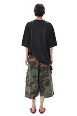 Back view of a model wearing Masonprince patchwork tee in black with camouflage cargo shorts