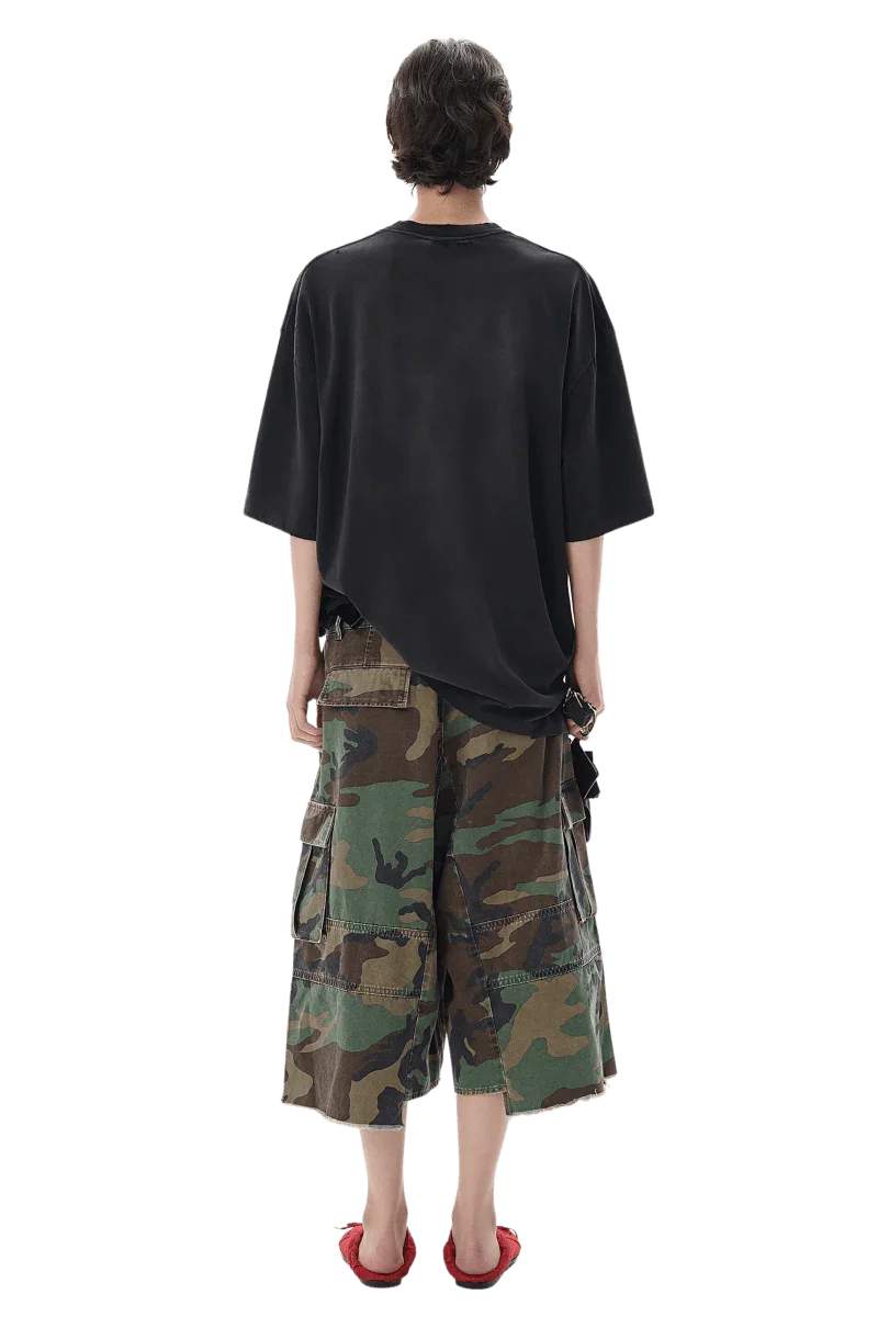 Back view of a model wearing Masonprince patchwork tee in black with camouflage cargo shorts
