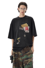 Masonprince patchwork tee in black with decorative patches worn by model with camo pants