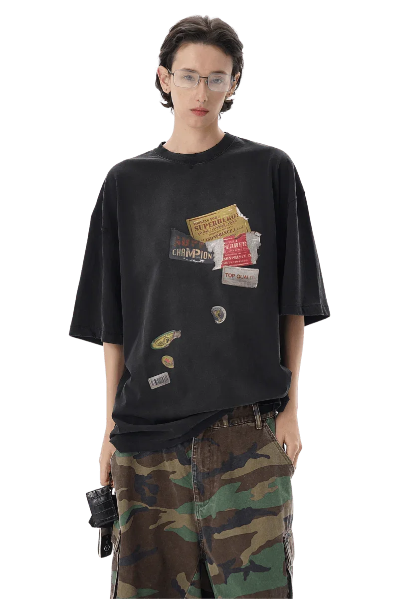 Masonprince patchwork tee in black with decorative patches worn by model with camo pants