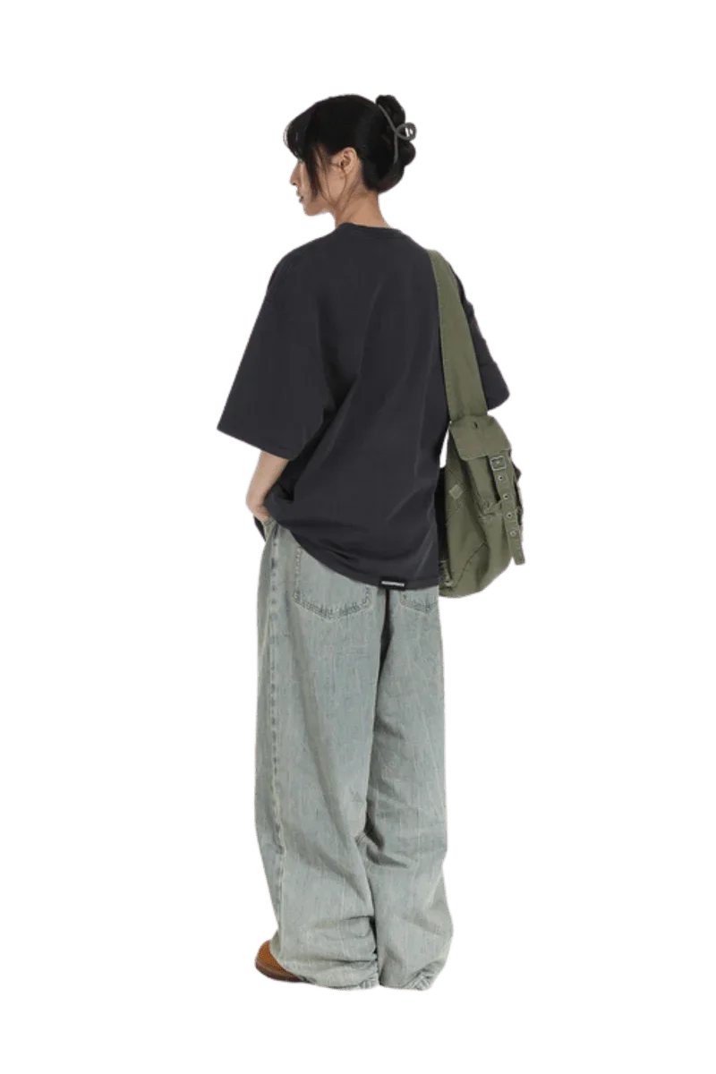 Masonprince Portrait Paint Tee in Black, styled with loose jeans and an olive green bag