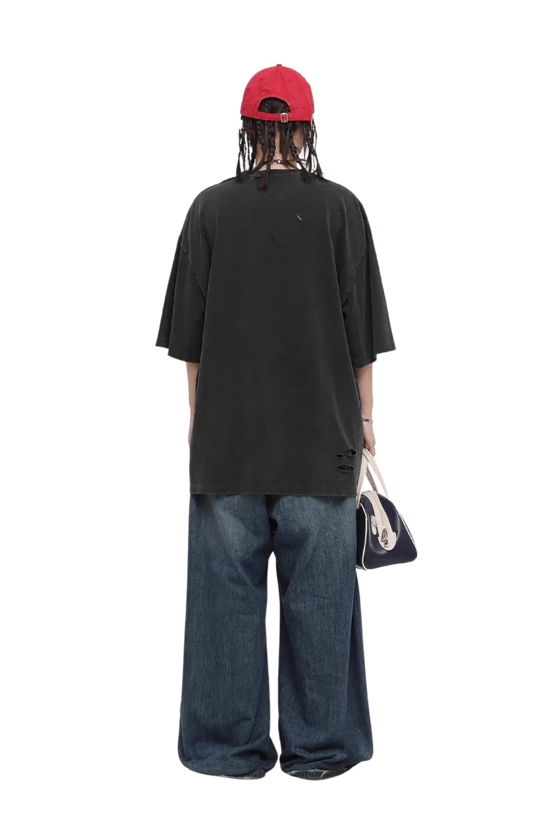 Back view of model wearing Masonprince black Real World Tee with loose fit and distressed details