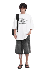 Masonprince white Real World Tee with black text worn with gray denim shorts and black sandals