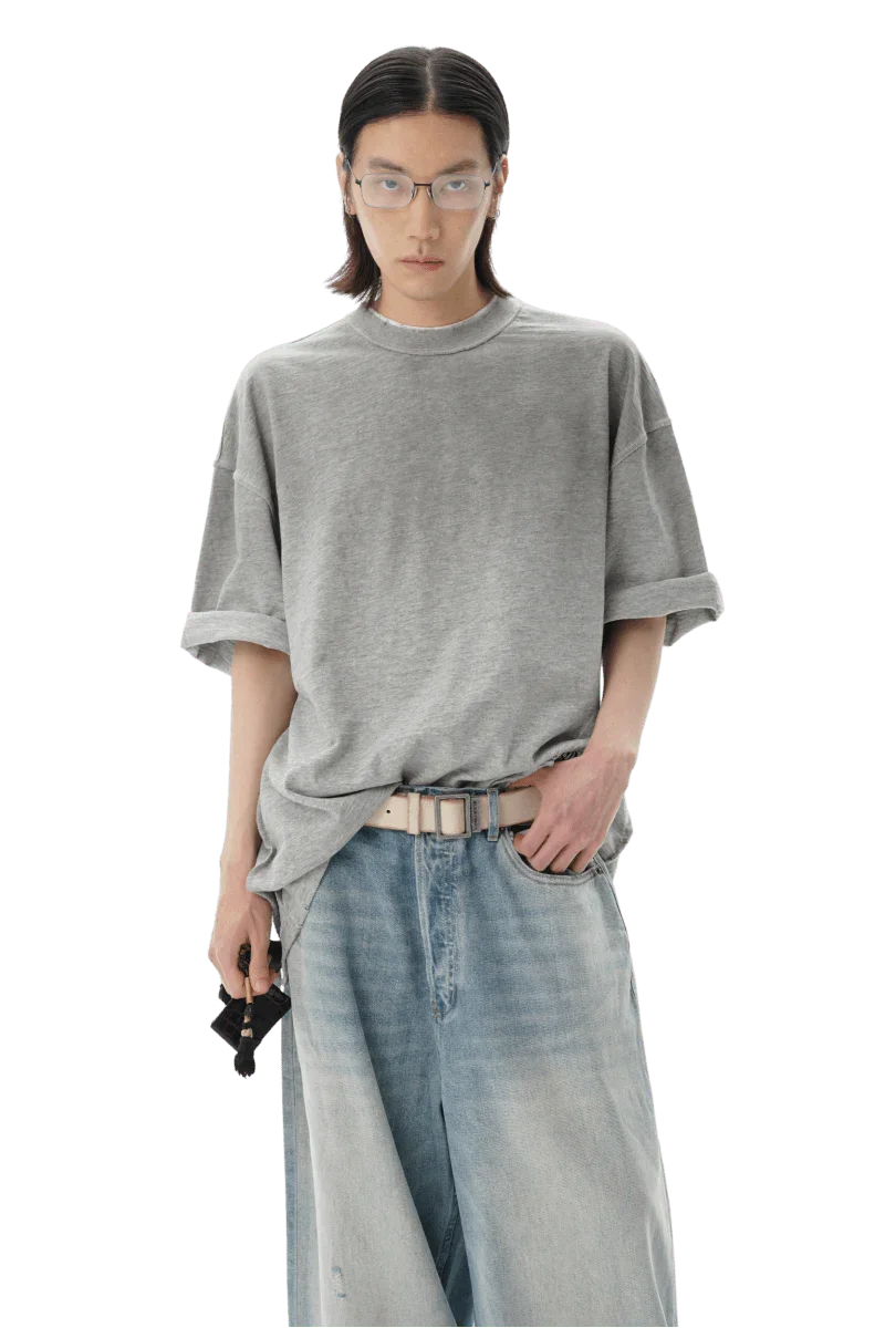 Model wearing a gray Masonprince reversed style tee with rolled sleeves and light wash jeans