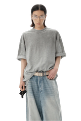 Model wearing a gray Masonprince reversed style tee with rolled sleeves and light wash jeans