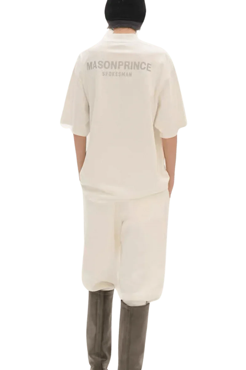 Back view of person wearing Masonprince Spokesman tee in off-white with matching pants and black hat