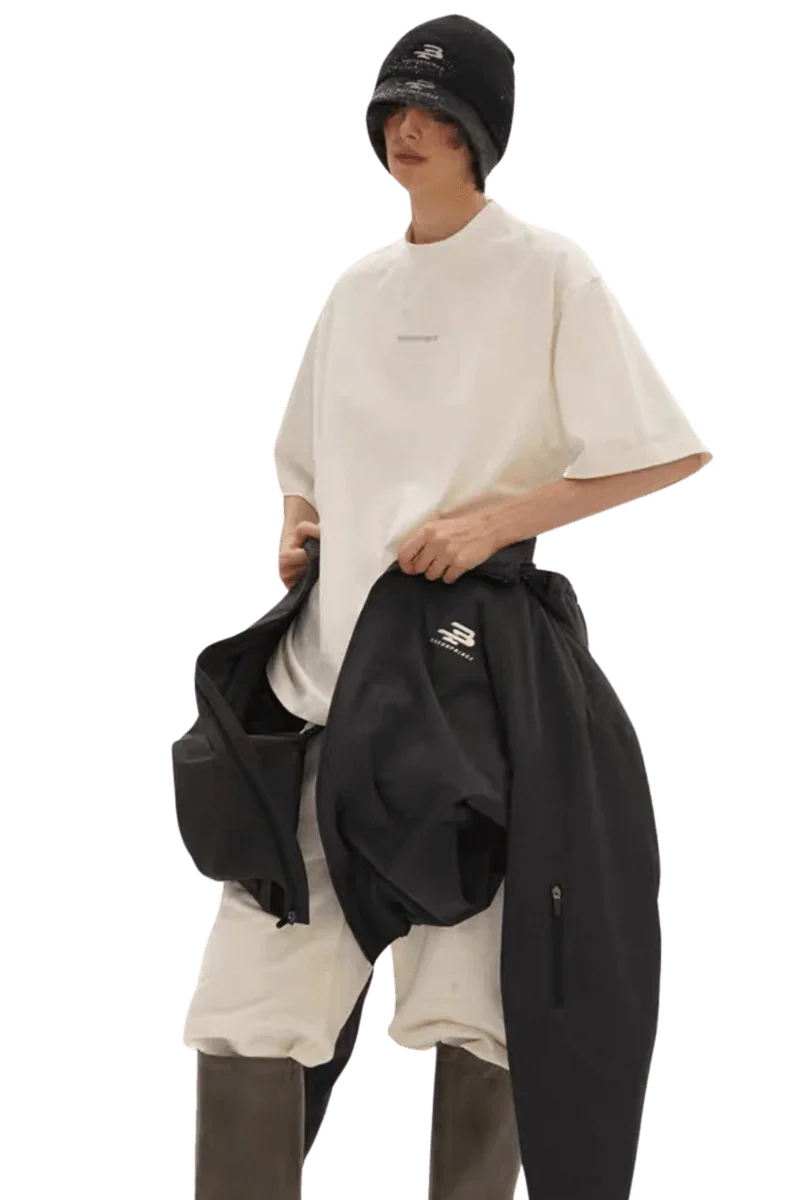 Model wearing Masonprince Spokesman tee in white with oversized fit and black outerwear