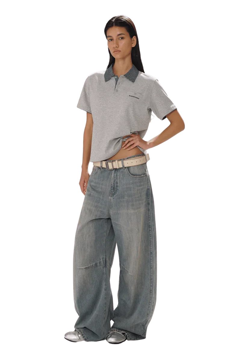 Model wearing Masonprince SS25 Polo Tee in gray with contrast collar paired with wide-leg jeans