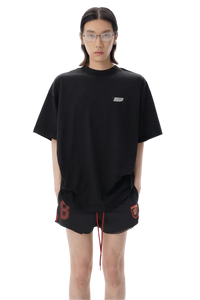 Model wearing black Masonprince SS25 Tape Tee with relaxed fit and small chest logo