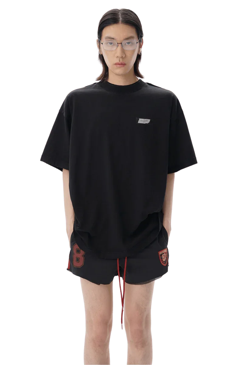 Model wearing black Masonprince SS25 Tape Tee with relaxed fit and small chest logo