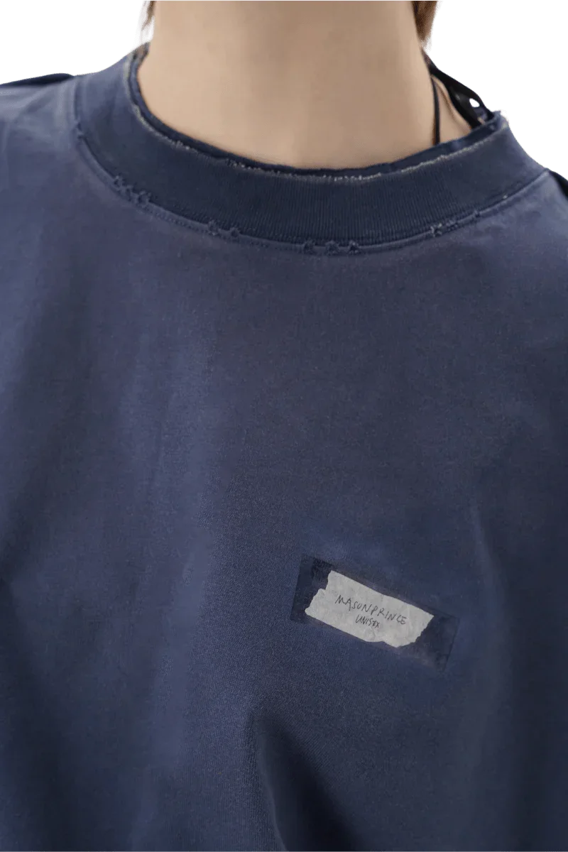 Close-up of Masonprince SS25 Tape Tee navy blue shirt with distressed neckline and small chest label