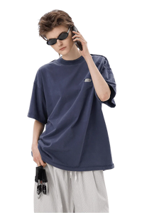 Masonprince SS25 Tape Tee in navy blue worn by model with sunglasses and white pants