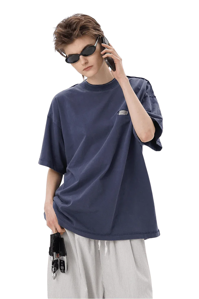 Masonprince SS25 Tape Tee in navy blue worn by model with sunglasses and white pants