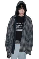 Masonprince SS25 VIP Tee worn under a black and gray checkered hooded shirt with gray pants