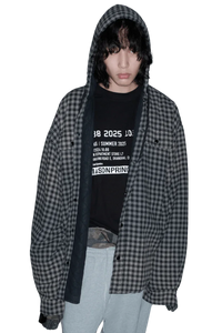 Masonprince SS25 VIP Tee worn under a black and gray checkered hooded shirt with gray pants