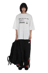 Masonprince SS25 VIP Tee white oversized shirt with black printed text worn by model