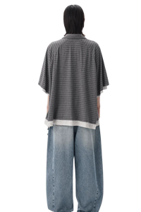 Back view of Masonprince Stripes Polo Tee in gray with horizontal stripes worn with loose blue jeans