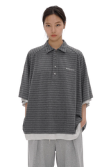 Front view of a model wearing Masonprince Stripes Polo Tee in gray with subtle horizontal stripes and button-up collar