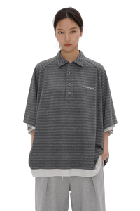 Front view of a model wearing Masonprince Stripes Polo Tee in gray with subtle horizontal stripes and button-up collar