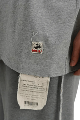 Close-up of gray Masonprince Tag Drop Tee showing fabric texture and signature tags on hem and lining