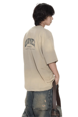 Masonprince beige unisex logo tee with printed design on back worn by model with jeans
