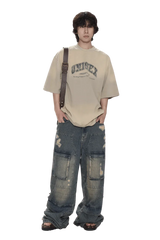 Masonprince unisex logo tee in beige worn with distressed baggy jeans and crossbody strap