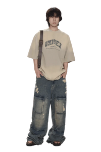 Masonprince unisex logo tee in beige worn with distressed baggy jeans and crossbody strap