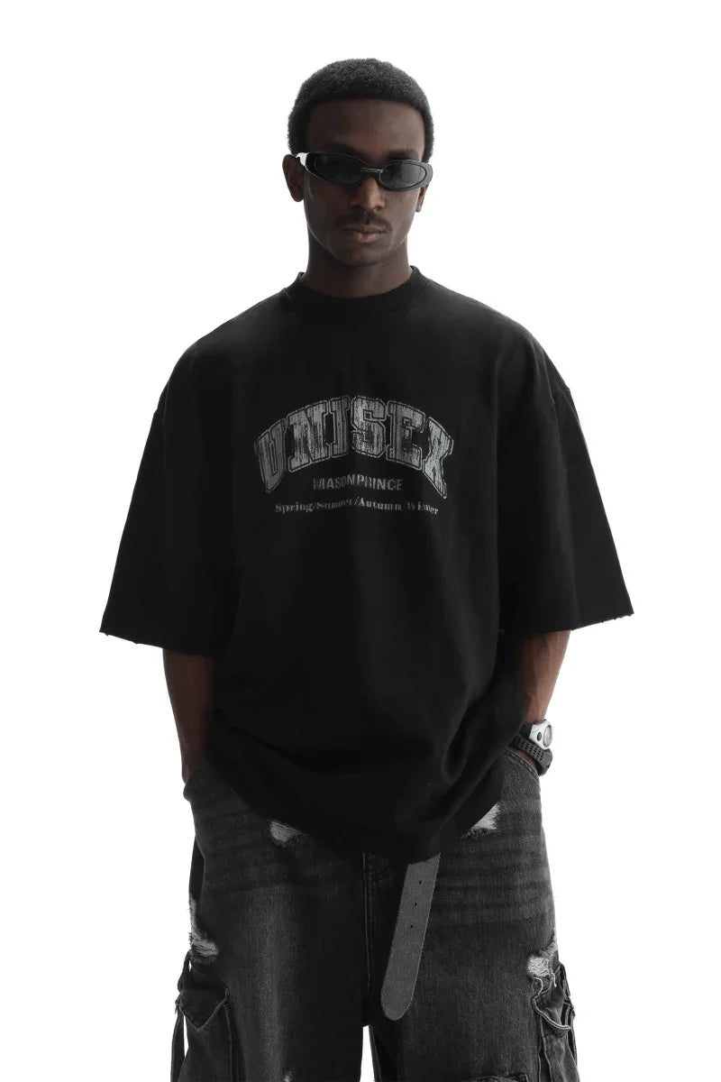 Masonprince unisex logo tee in black worn by model with sunglasses and ripped jeans