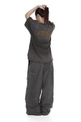 Masonprince unisex logo tee in dark gray worn by model seen from back with casual oversized pants