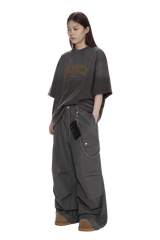 Masonprince unisex logo tee in charcoal gray with oversized fit worn by model with loose pants