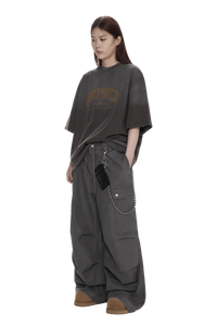 Masonprince unisex logo tee in charcoal gray with oversized fit worn by model with loose pants