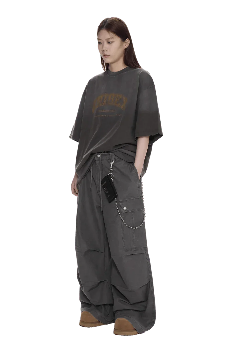 Masonprince unisex logo tee in charcoal gray with oversized fit worn by model with loose pants