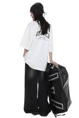 Masonprince unisex logo tee worn by model with black beanie and wide black pants holding large black bag