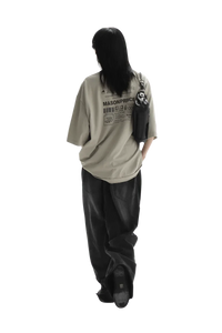 Person wearing beige Masonprince WashTag Tee with graphic print on back and black pants