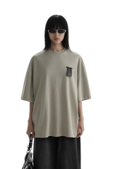 Masonprince WashTag Tee oversized beige shirt with black wash tag detail worn by model with sunglasses