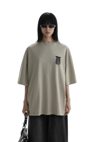 Masonprince WashTag Tee oversized beige shirt with black wash tag detail worn by model with sunglasses